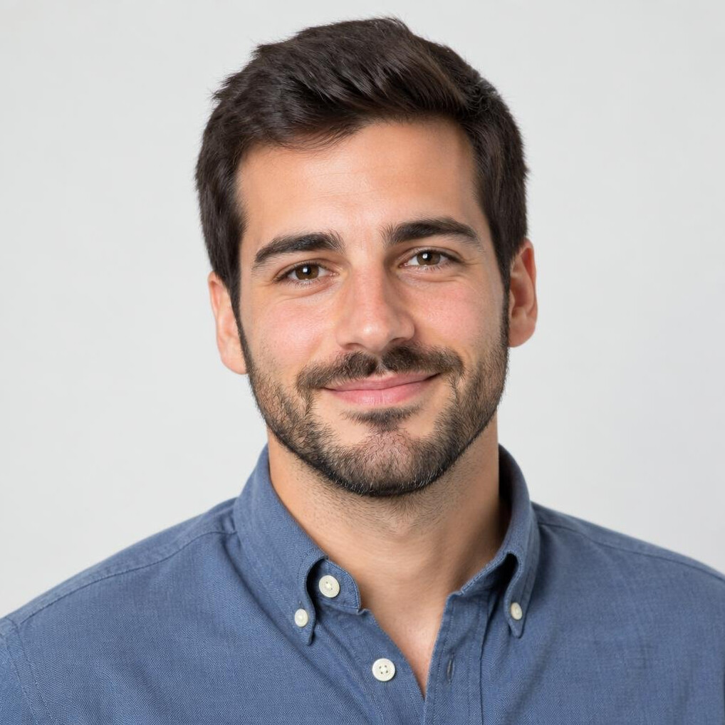 Studio portrait of a young Portuguese man with short dark hair and beard