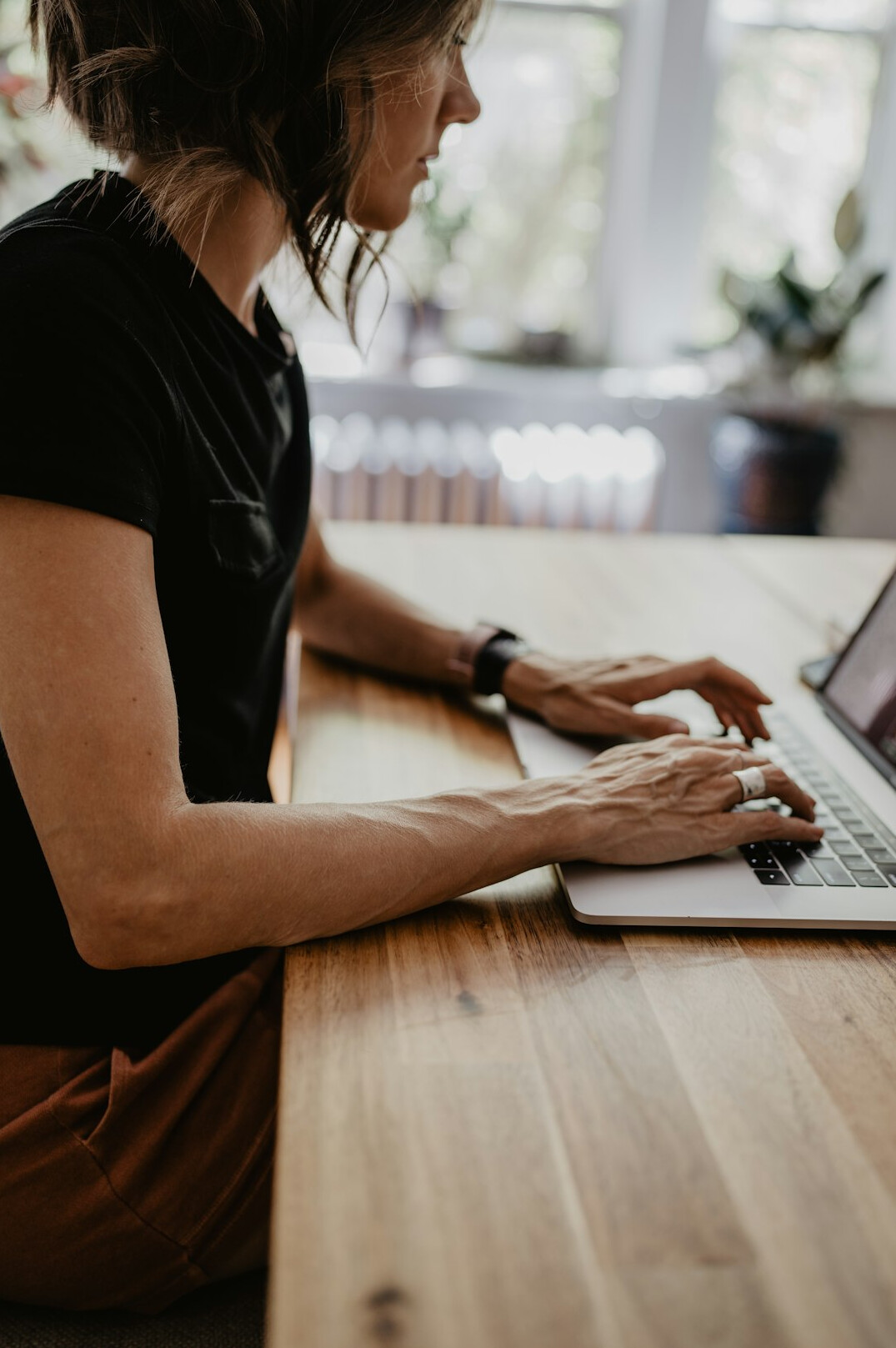 person checking laptop at desk
