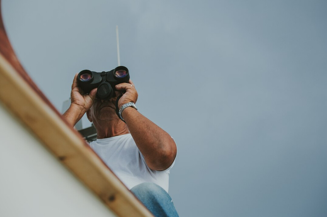 private investigator using binoculars