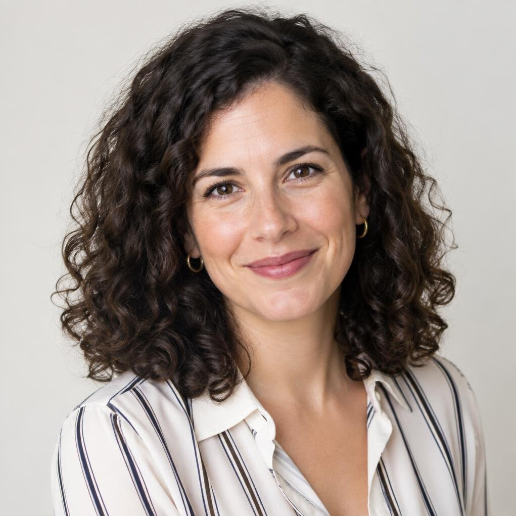 Studio portrait of a Portuguese woman with dark curly hair